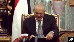 Yemeni President Ali Abdullah Saleh signs a document agreeing to step down after a long-running uprising to oust him from 33 years in power in Riyadh, Saudi Arabia, Nov. 23, 2011.