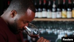 Zimbabwean Tinashe Nyamudoka, a famed sommelier with his own wine brand, smells a glass of wine during an interview with Reuters in Johannesburg, South Africa, June 25, 2021. Picture taken June 25, 2021. REUTERS/Siphiwe Sibeko