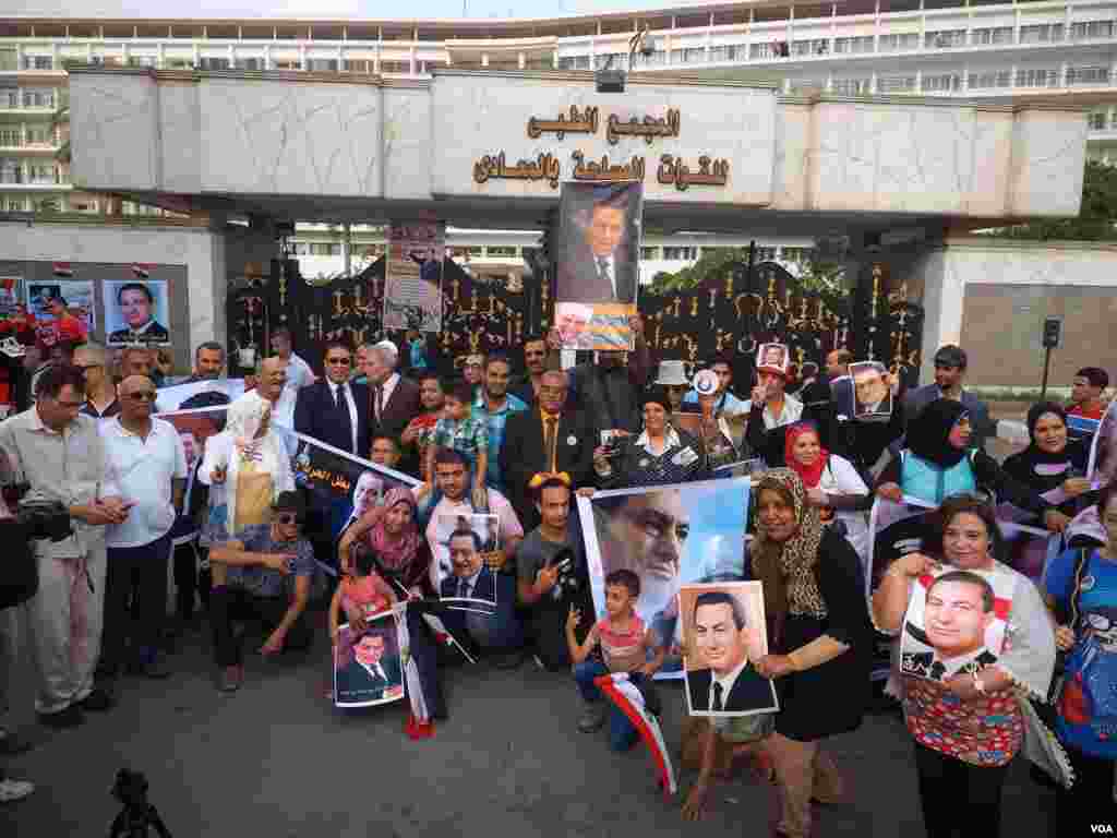 On the anniversary of Egypt&#39;s 1973 military victory in the Sinai Peninsula, supporters of then-General Hosni Mubarak celebrate outside the hospital where he is being treated. The ousted president is set to stand trial again next month, Cairo, Oct. 6, 2015.