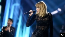 FILE - Taylor Swift performs at DIRECTV NOW Super Saturday Night Concert at Club Nomadic in Houston, Texas. 