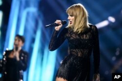 FILE - Taylor Swift performs at DIRECTV NOW Super Saturday Night Concert at Club Nomadic in Houston, Texas.