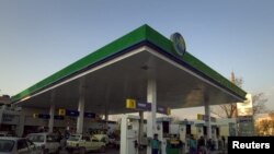 Motorists at petrol station in Islamabad. Pakistan increased petrol prices 