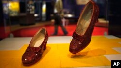 FILE - Dorothy's ruby slippers from the "Wizard of Oz" are seen on display as part of a new exhibit, "American Stories," at the Smithsonian National Museum of American History in Washington, Apr. 11, 2012. 
