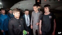 From left: Chechen regional leader Ramzan Kadyrov accompanied by Russian journalists Oleg Sidyakin and Marat Saichenko addresses media following release from captivity in Ukraine, Grozny, Chechnya, May 25, 2014.