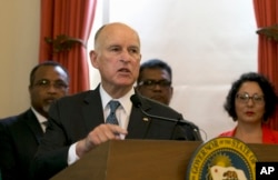 FILE - In this June 13, 2017, file photo, California Gov. Jerry Brown discusses climate change at a news conference in Sacramento, Calif. Brown plans to convene a Global Climate Action Summit next year in his latest action to position the state as a leade