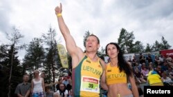 Vytautas Kirkliauskas of Lithuania and his wife, Neringa Kirkliauskiene, celebrate after winning this year's World Wife-Carrying Championship in Sonkajarvi, Finland, July 7, 2018.