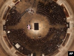 The flag-draped casket of former President George H.W. Bush is carried by a joint services military honor guard into the U.S. Capitol Rotunda Monday, Dec. 3, 2018, in Washington. (Pool photo by Morry Gash via AP)