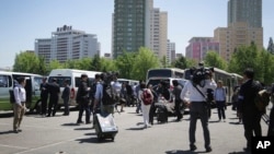 Foreign journalists leave a venue after being told that coverage plans had changed until further notice in Pyongyang, North Korea, May 8, 2016.
