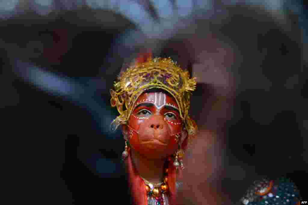 A child dressed as Hindu god Lord Hanuman waits to perform during a fancy dress competition at a school in Amritsar, India.