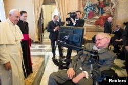 FILE - Pope Francis greets Stephen Hawking, theoretical physicist and cosmologist, during a meeting with the Pontifical Academy of Sciences in Vatican, Nov. 28, 2016.