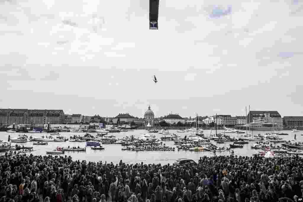 David Colturi of the USA dives from the 28-meter platform on the roof of the Copenhagen Opera House during the second stop of the Red Bull Cliff Diving World Series in Copenhagen, Denmark, June 22, 2013. Artem SIlchenko of Russia won the event, followed by Gary Hunt of the UK and third Orlando Duque of Colombia.