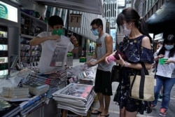 People queue up at a news stand to buy copies of Apple Daily in downtown Hong Kong, Aug. 11, 2020, as a show of support, a day after the arrest of its founder Jimmy Lai.