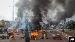 FILE - Anti-government protesters burn tires and barricade roads in the capital Bamako, Mali, July 10, 2020, rejecting the president's promises of reforms.