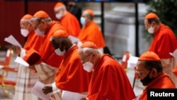 Cardinals wearing protective masks attend a consistory ceremony at St. Peter's Basilica at the Vatican, Nov. 28, 2020.