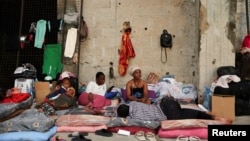 Women and a kid  from Sierra Leone remainder  astatine  a structure  for displaced migrant workers, successful  Hazmieh, Lebanon, Oct. 5, 2024.