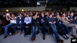 FILE - Audience members applause a speaker during a keynote address at the Microsoft Build 2017 developers conference Thursday, May 11, 2017, in Seattle.