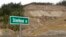Photo taken March 17, 2015 shows a new sign for Steelhead Drive in Oso, Wash., in front of a hillside scarred by the deadly mudslide that killed 43 people on March 22, 2014.