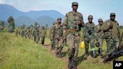 Congolese army soldiers march on a reconnaissance mission near Kibumba Hill, which is occupied by M23 rebels, around 25km from the provincial capital Goma, in eastern Congo Sunday, Oct. 27, 2013. The Congolese army says it has taken two more towns in the 