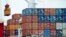 FILE - A container is loaded onto a cargo ship at the Tianjin port in China. 