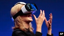 FILE - British television presenter Rachel Riley wears a virtual-reality headset at a consumer electronic fair in Berlin, Sept. 3, 2014. A study in the Netherlands found that therapy using virtual reality was helpful in reducing paranoia and anxiety in psychotic patients.