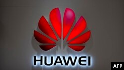 FILE - The Huawei logo is seen at a Huawei store at a shopping mall in Beijing, July 4, 2018. The Chinese-owned telecommunications giant has been blocked from rolling out Australia's 5G network because of security concerns.