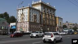 Vehicles drive past the U.S. Embassy in Moscow, Aug. 21, 2017. 