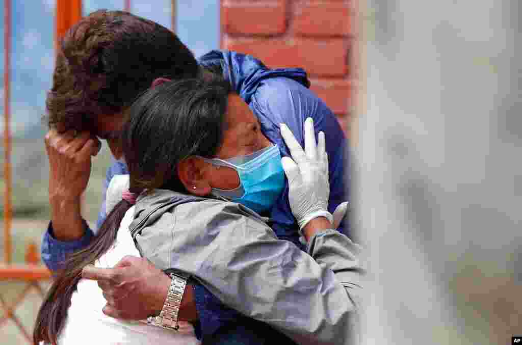 Relatives of a person who died from the coronavirus disease collect ashes at the spot where he was cremated, as part of a ritual at a crematorium in New Delhi, India.