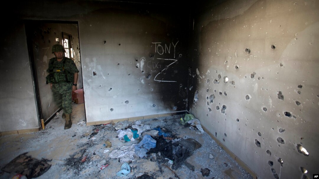 Seorang tentara memasuki rumah penuh peluru, yang ditandai dengan inisial CDG (Kartel Teluk), dan Z (Zetas), di Ciudad Victoria, di negara bagian Tamaulipas, Meksiko, 6 September 2014. (Foto: dok).
