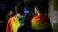 Two men draped in rainbow flags are seen in a nightclub in Bucharest, Romania, Oct. 7, 2018, following a referendum on marriage which was voided due to low voter turnout.