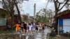 FILE - People use ropes to remove fallen trees following the impact of Typhoon Yagi, Hai Phong, Vietnam, Sept. 8, 2024. 