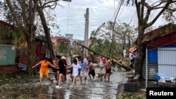 FILE - People use ropes to remove fallen trees following the impact of Typhoon Yagi, Hai Phong, Vietnam, Sept. 8, 2024. 