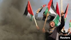 Palestinians take part in a protest