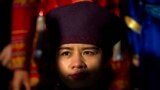 An ethnic minority delegate poses for a group photo with other delegates before a plenary session of the National People&#39;s Congress (NPC) at the Great Hall of the People in Beijing.