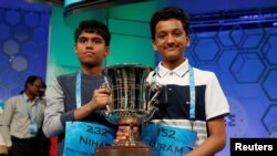 FILE - Co-champions Nihar Janga, left, and Jairam Hathwar hold their trophy upon completion of the final round of Scripps National Spelling Bee at National Harbor, Maryland, May 26, 2016.