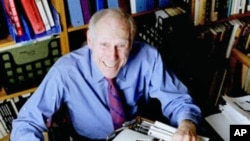 In this file photo from 1998, publisher Barney Rosset poses with some of his favorite things in his New York loft. Rosset died Tuesday, Feb. 21, 2012 in New York.