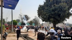 People flee to safety during an anti-coup protest in Loikaw, Myanmar March 9, 2021 in this still image obtained by Reuters ATTENTION EDITORS - THIS IMAGE HAS BEEN SUPPLIED BY A THIRD PARTY. NO RESALES. NO ARCHIVES.