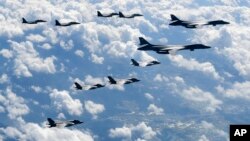 In this photo provided by South Korea Defense Ministry, U.S. Air Force B-1B bombers, F-35B stealth fighter jets and South Korean F-15K fighter jets fly over the Korean Peninsula during a joint drills, South Korea on Sept. 18, 2017. Flights over the Korean Peninsula have take place regularly in recent months.