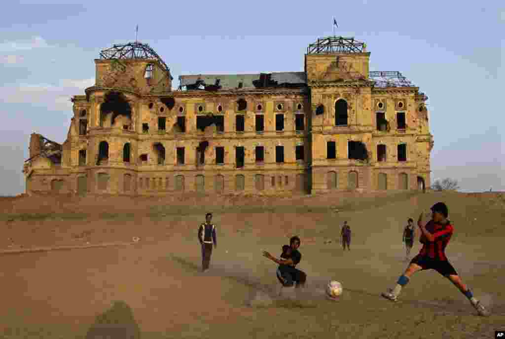 Afghan men play football in front of the old palace in Kabul December 7, 2010. (Omar Sobhani / Reuters)