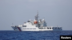 FILE - A China Coast Guard vessel patrols the disputed Scarborough Shoal, April 6, 2017.