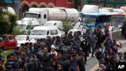 Uniformed federal police block the highway between Mexico City and Pachuca in both directions as part of a protest against plans to absorb them into the newly formed National Guard, in Ecatepec, Mexico, July 3, 2019.