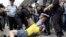 Policemen break up a fight between a gay rights activist and an anti-gay rights activist (in yellow) during a protest against a proposed new anti-gay law, Moscow June 11, 2013. 