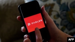 FILE - This photo shows the Parler logo on a smartphone in Arlington, Va., July 2, 2020. 