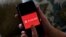 FILE - This photo shows the Parler logo on a smartphone in Arlington, Va., July 2, 2020. 