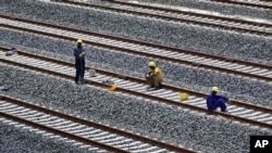 FILE - Kenyan laborers take a break as they work on the Nairobi-Mombasa railway, a Chinese project, near Nairobi on Nov. 23, 2016. The United States confirmed this week that it will take on its own infrastructure project in Zambia, the Democratic Republic of Congo and Angola.