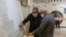FILE - People check names to receive their voter cards inside a polling station in Tripoli, Libya, Nov. 8, 2021.