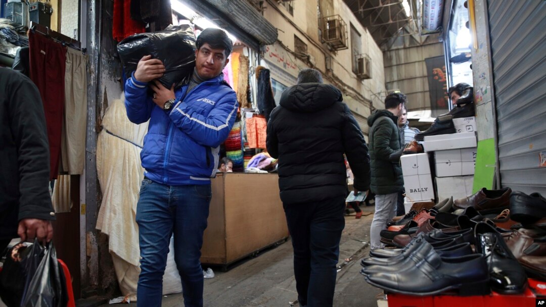 FILE - People conduct their business at the Grand Bazaar in Tehran, Iran, Feb. 7, 2019.