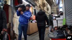 FILE - People conduct their business at the Grand Bazaar in Tehran, Iran, Feb. 7, 2019.