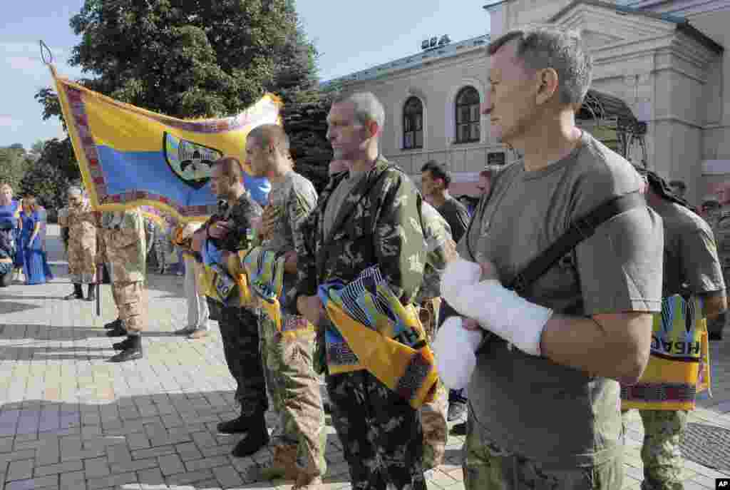 Volunteers of battalion &#39;Donbas&#39; hold battalion flags during a blessing ceremony in St. Michael Cathedral in Kyiv, Aug. 19, 2014.&nbsp;