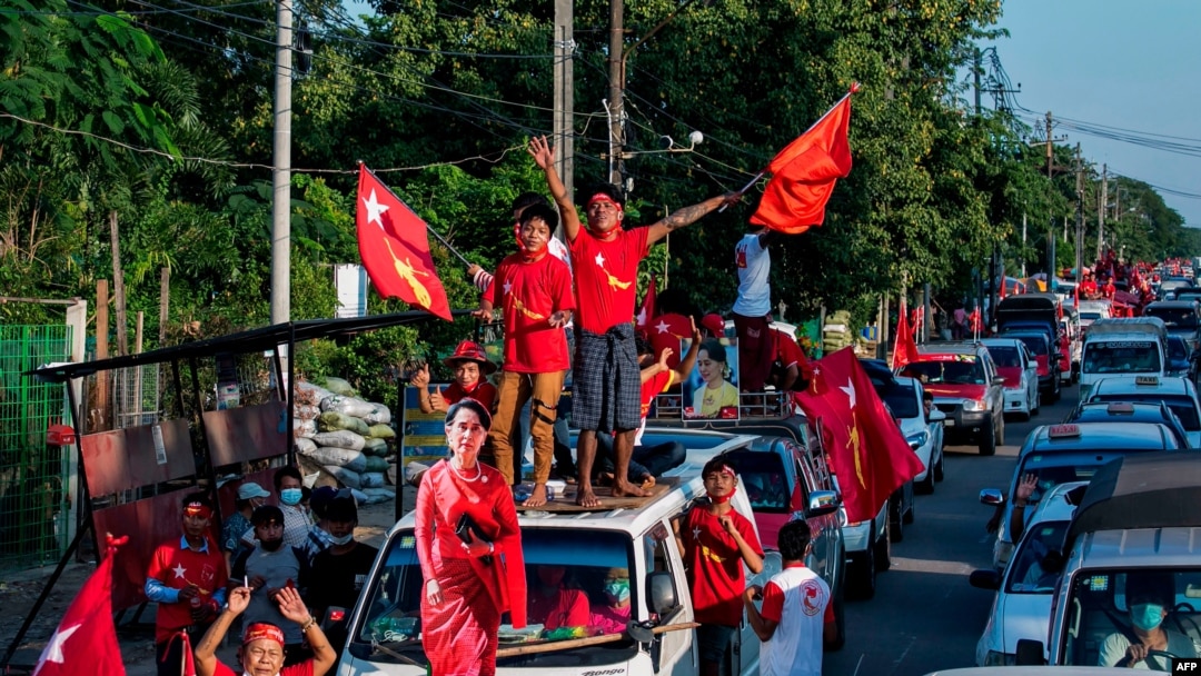 Supporters of the National League for Democracy (NLD) party celebrate with a cut-out figure of Myanmar state counsellor Aung San Suu Kyi in Yangon on November 10, 2020, as NLD officials said they were confident of a landslide victory in the weekend…