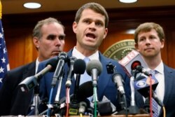 U.S. Attorney Thomas Cullen, center, speaks to reporters during a news conference after the sentencing of James Alex Fields Jr. in federal court in Charlottesville, Va., June 28, 2019.